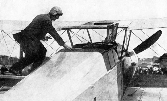 Hawker entering his aircraft to take passengers tor a flight at Hendon