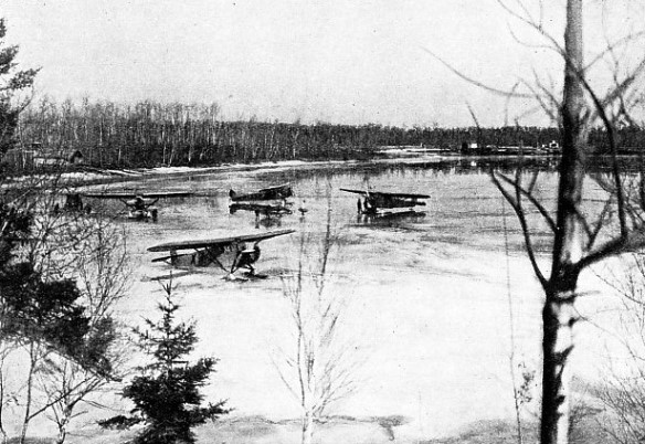 MILITARY AND COMMERCIAL aeroplanes, fitted with skis, on Lac du Bonnet, Manitoba