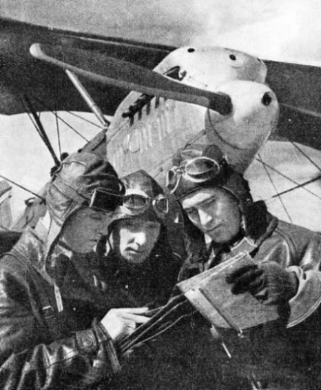 RUSSIAN MILITARY FLIERS discussing their route before a flight