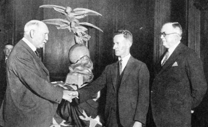 Sir Granville Ryrie, High Commissioner for Australia in 1927-32, is presenting to Kingsford Smith the 1928 trophy awarded by the International League of Aviators