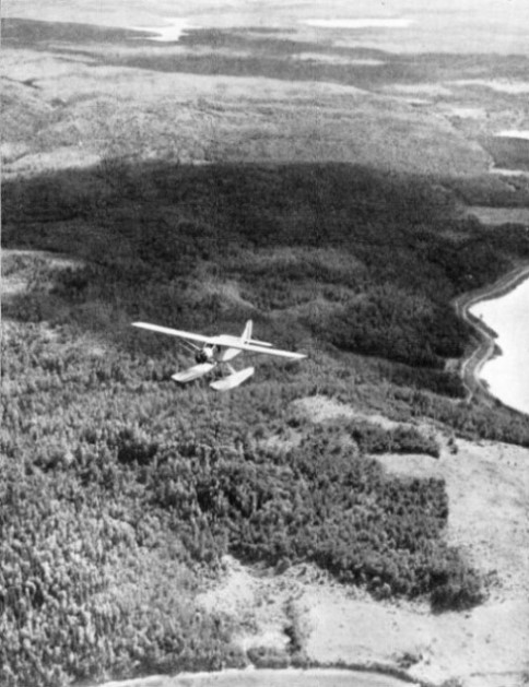 SEAPLANE OVER TYPICAL FOREST LAND of Canada in the neighbourhood of Blue Sea Lake, Quebec