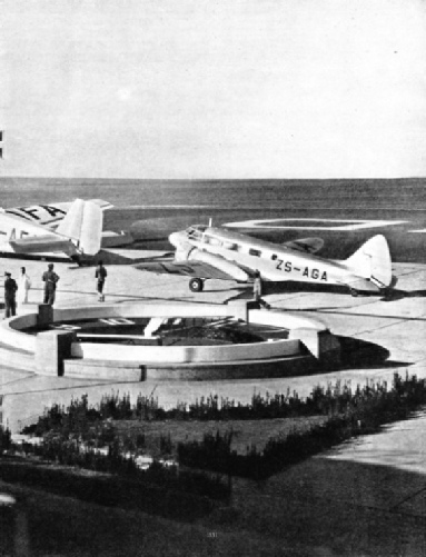 AIRCRAFT IN FRONT OF THE BUILDINGS AT THE RAND AIRPORT