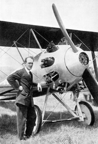 A SOPWITH BIPLANE with Hawker standing alongside